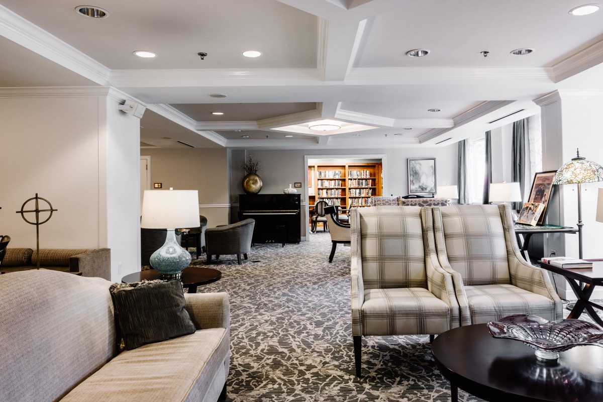 A cozy lounge area with comfortable seating and a small library.