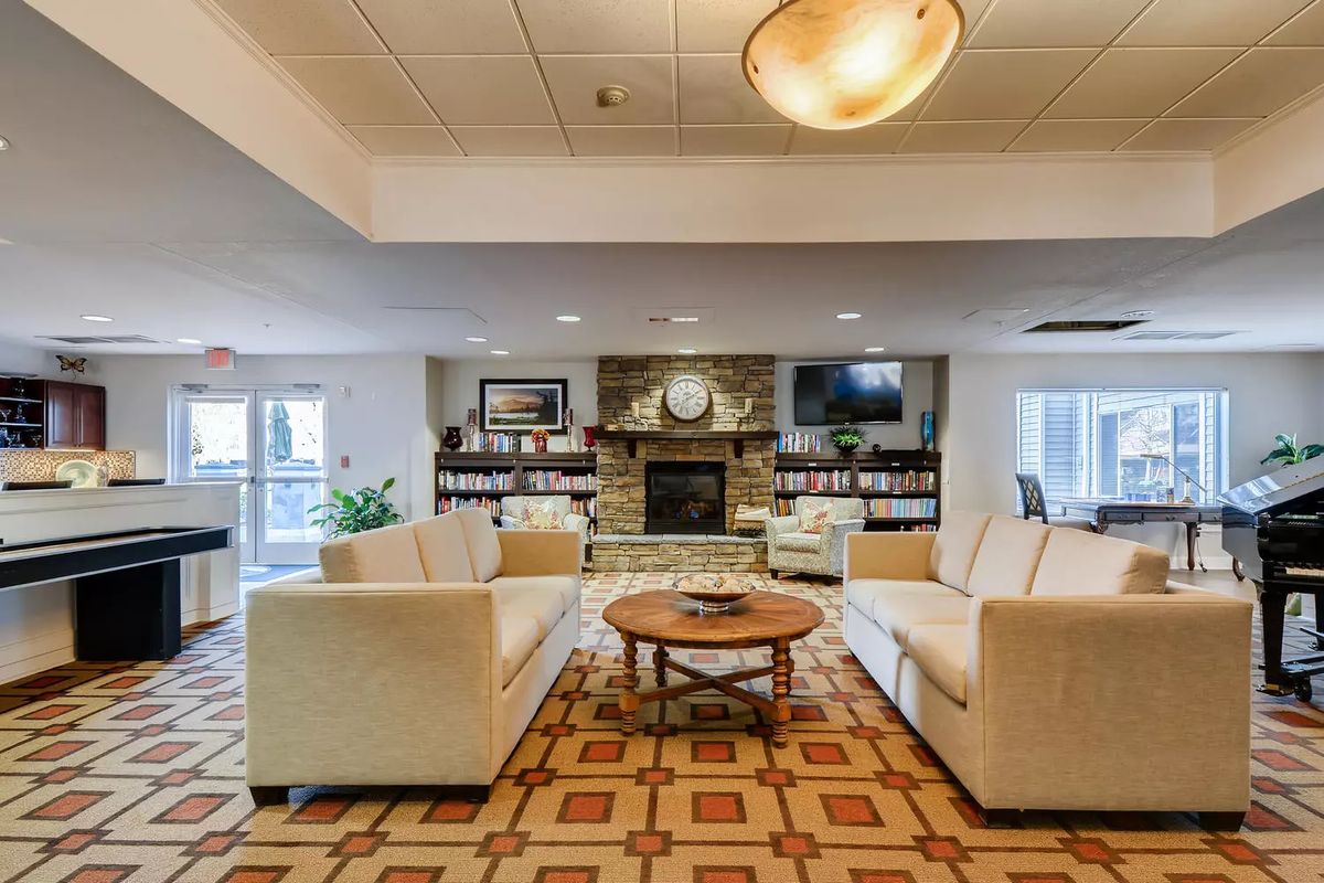 A modern and cozy living room with comfortable sofas and a fireplace as the focal point.