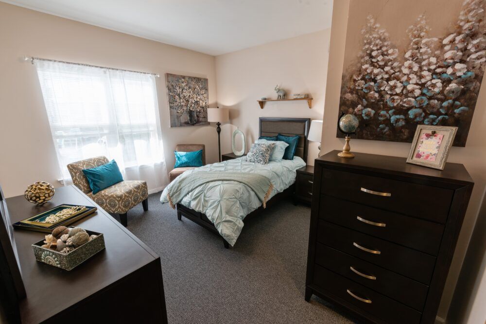 A cozy bedroom with a neatly made bed and elegant decor.