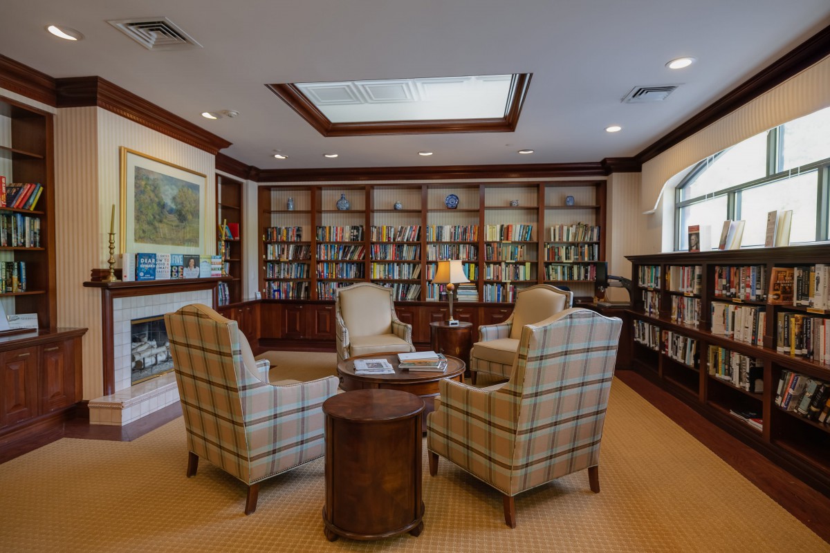 A cozy reading room with armchairs and bookshelves.