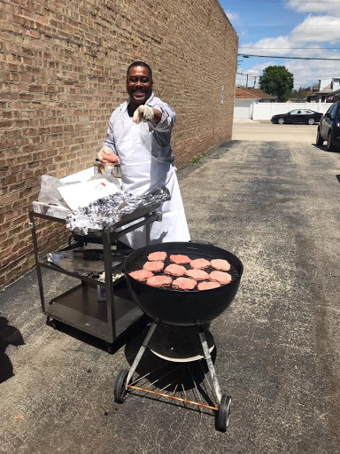 A chef grilling hamburgers outdoors, ready to serve delicious food.