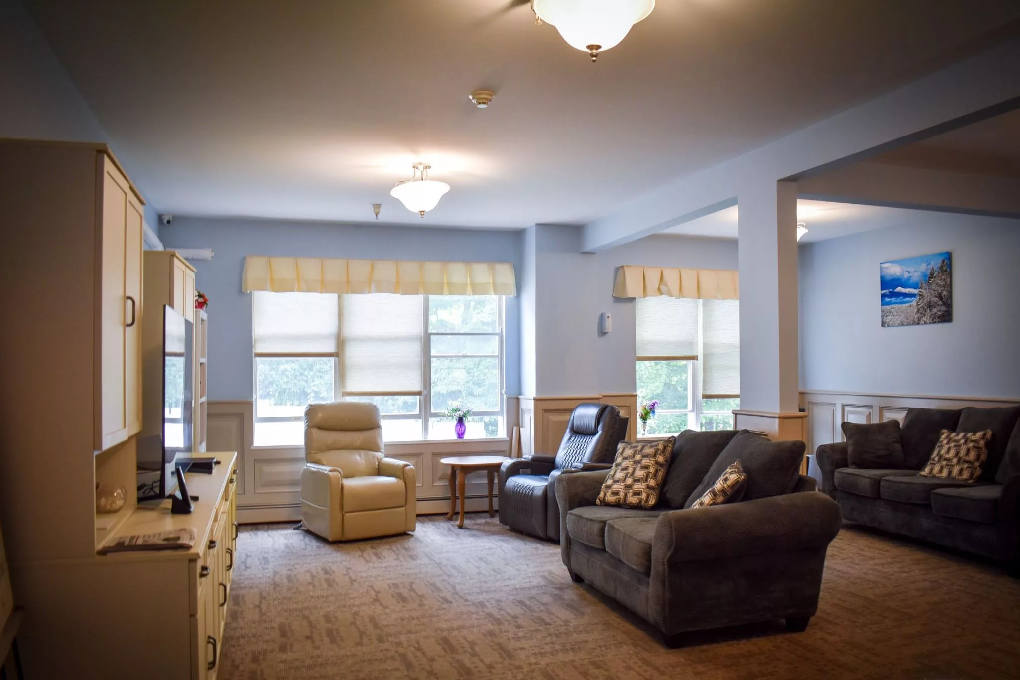 A cozy living room with comfortable seating and large windows.