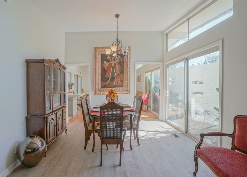 A modern dining room with elegant furniture and ample natural light.