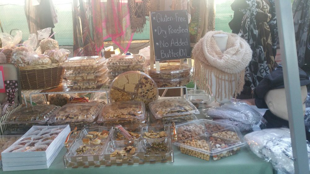A variety of cookies and baked goods displayed at a market stall.