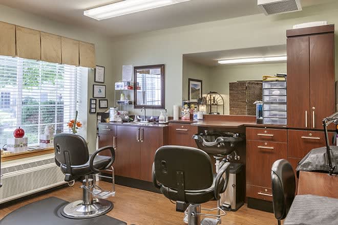 A well-organized barbershop with multiple chairs and haircut stations.