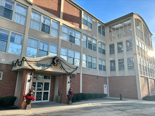 A well-lit apartment building decorated for the holidays.