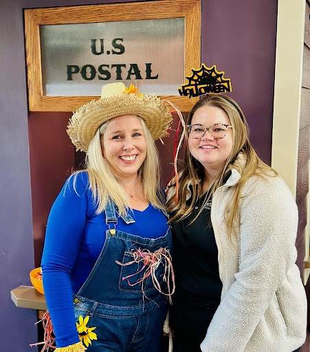 Two friends enjoying a festive moment at a themed gathering.