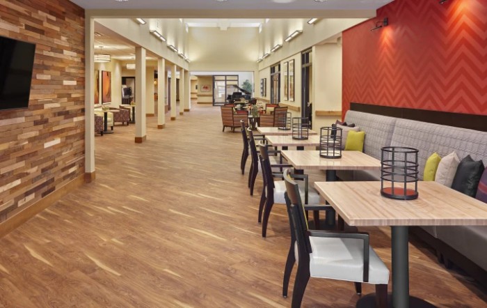 A modern dining area featuring wood flooring, sleek furniture, and contemporary decor.