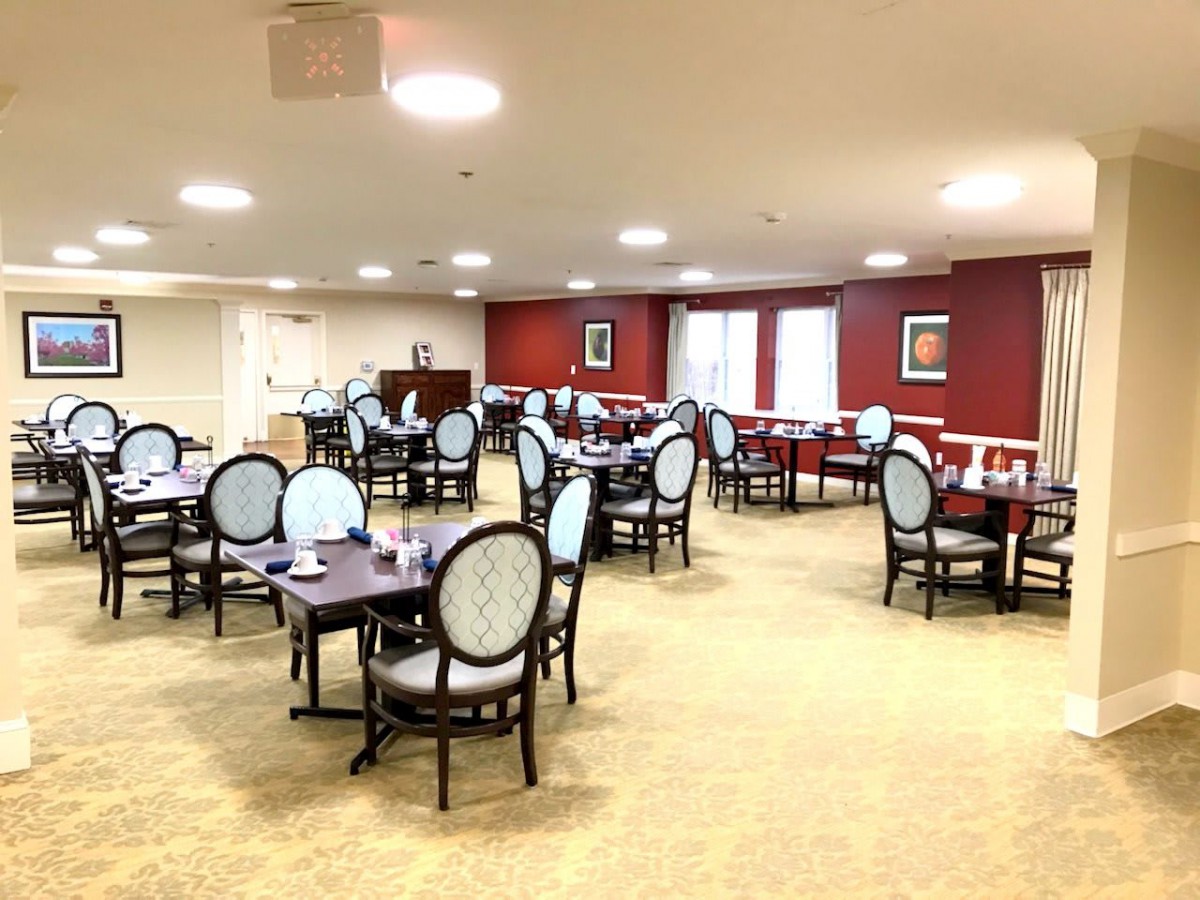An empty dining area with neatly arranged tables and chairs.