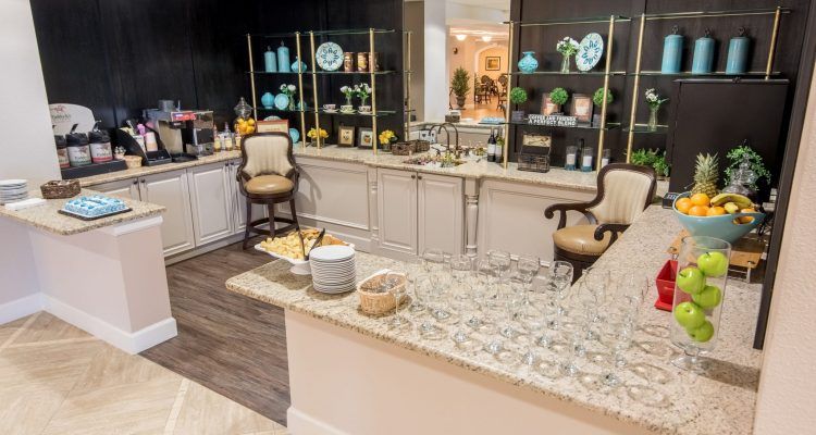A sophisticated bar area with elegant decor and a counter lined with glasses.