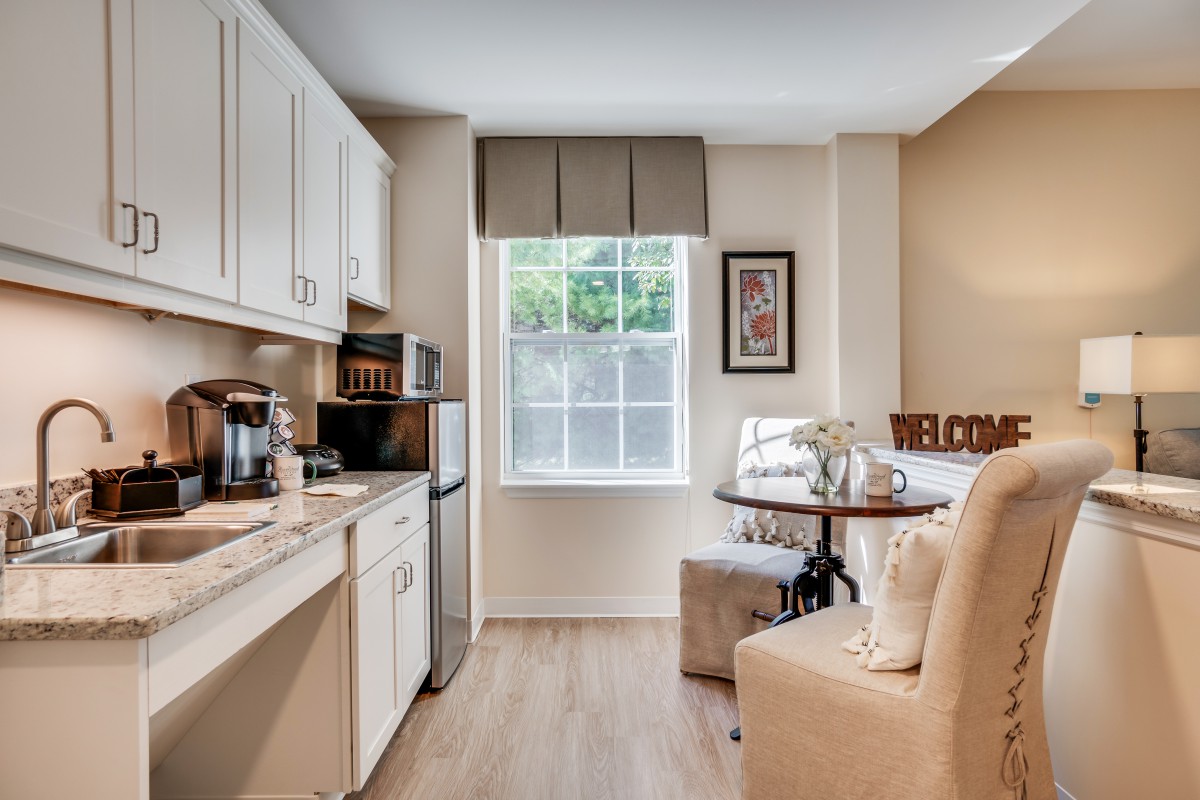 A cozy kitchen and dining area in a small apartment with modern design elements.