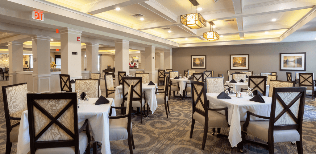 An elegant restaurant dining room with well-arranged tables and chairs.