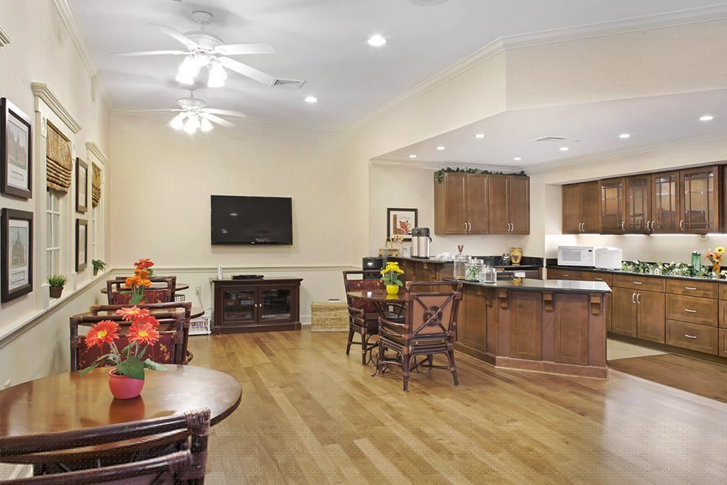 Spacious open-concept living and kitchen area with hardwood floors and modern furnishings.