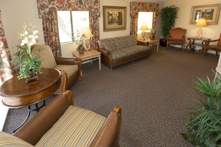 A cozy living room with comfortable seating, lamps, and decorative elements.