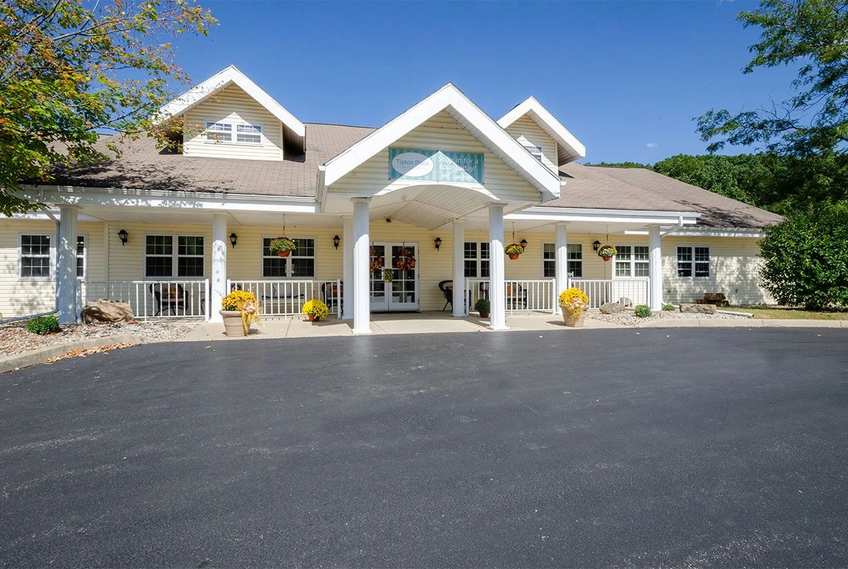 A suburban residential building with a welcoming porch and columns.