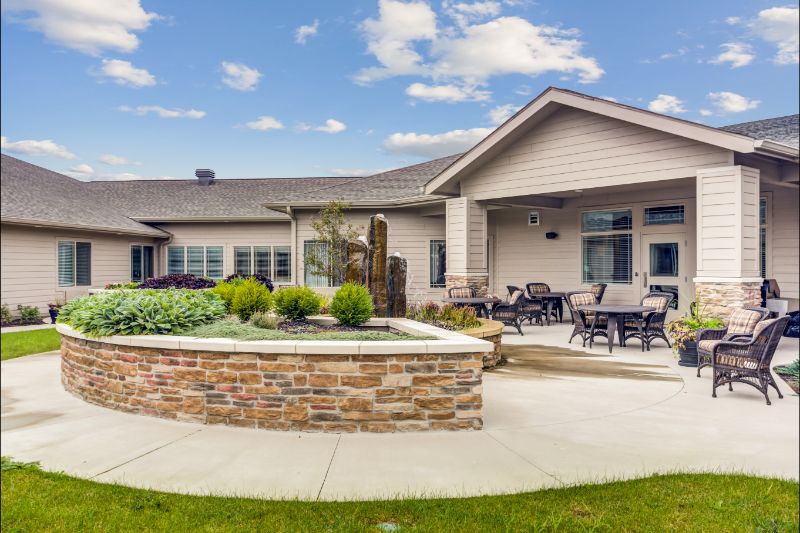 A modern residential home with a spacious patio area and well-maintained landscaping.