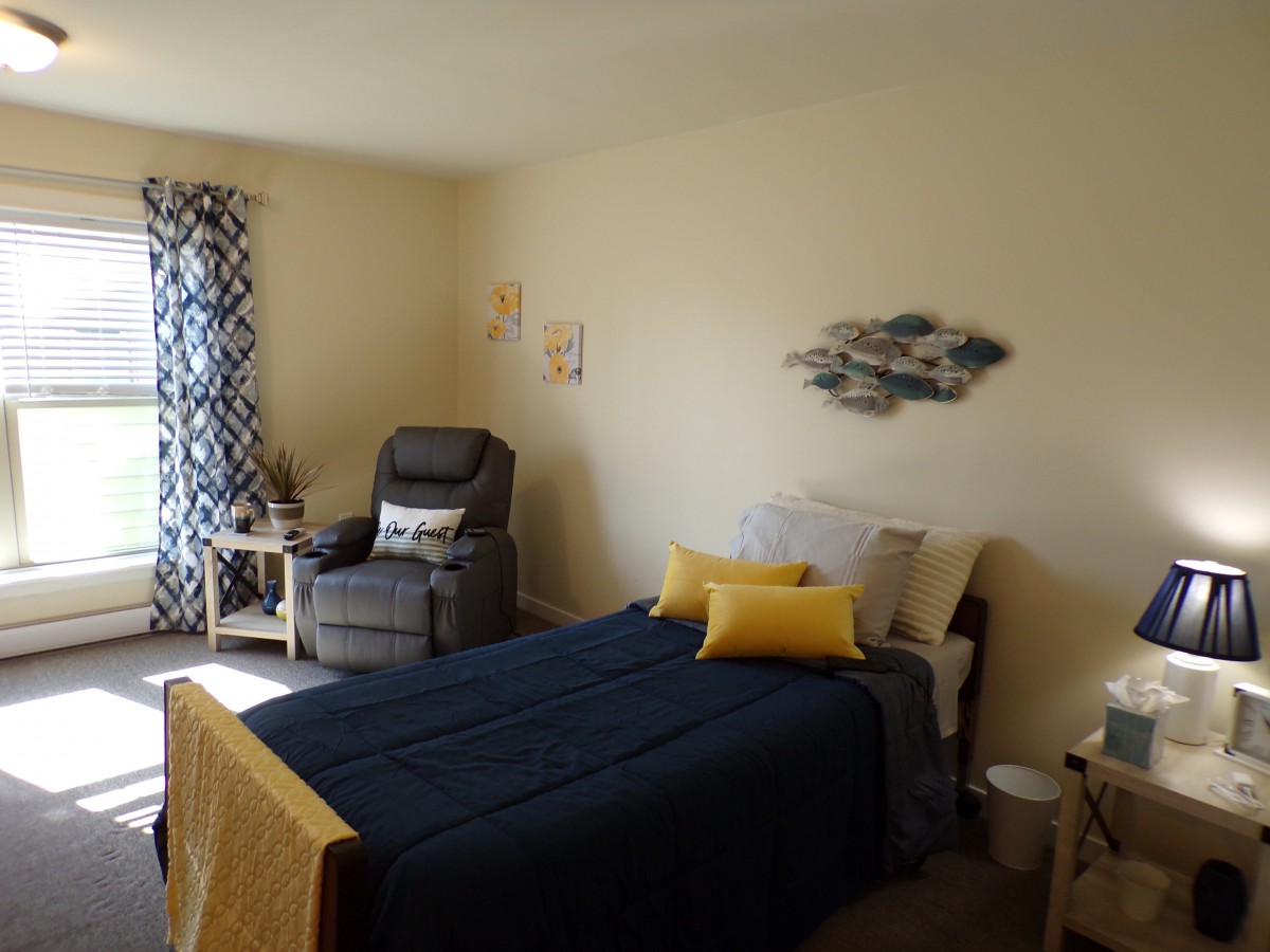 Cozy bedroom with a bed, armchair, and decorative accents.