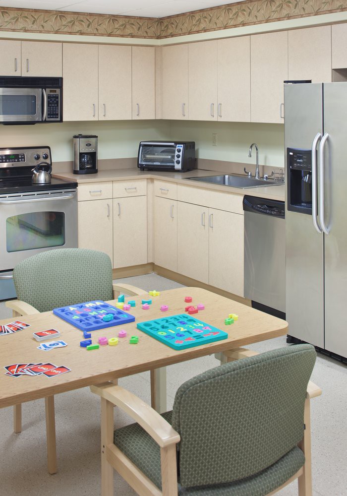 A modern kitchen with a table set up for board games.