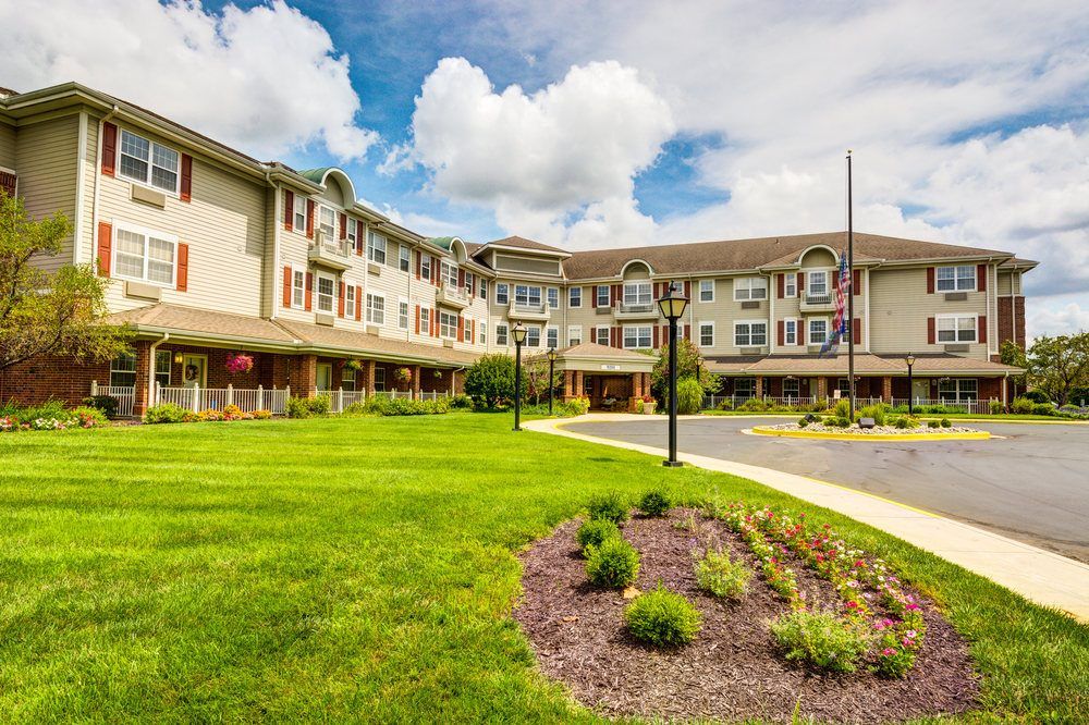 Beautiful residential building with well-maintained landscaping under a cloudy sky.