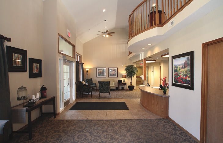 A well-lit lobby with a reception desk and seating area.
