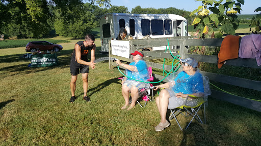 Enjoying a sunny day outdoors, socializing in camping chairs.