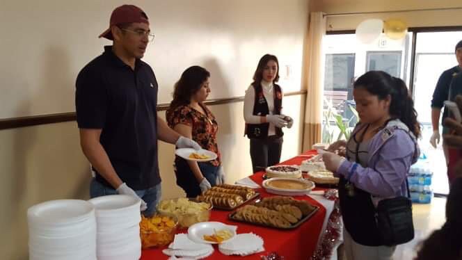 Volunteers serving food at a community event.