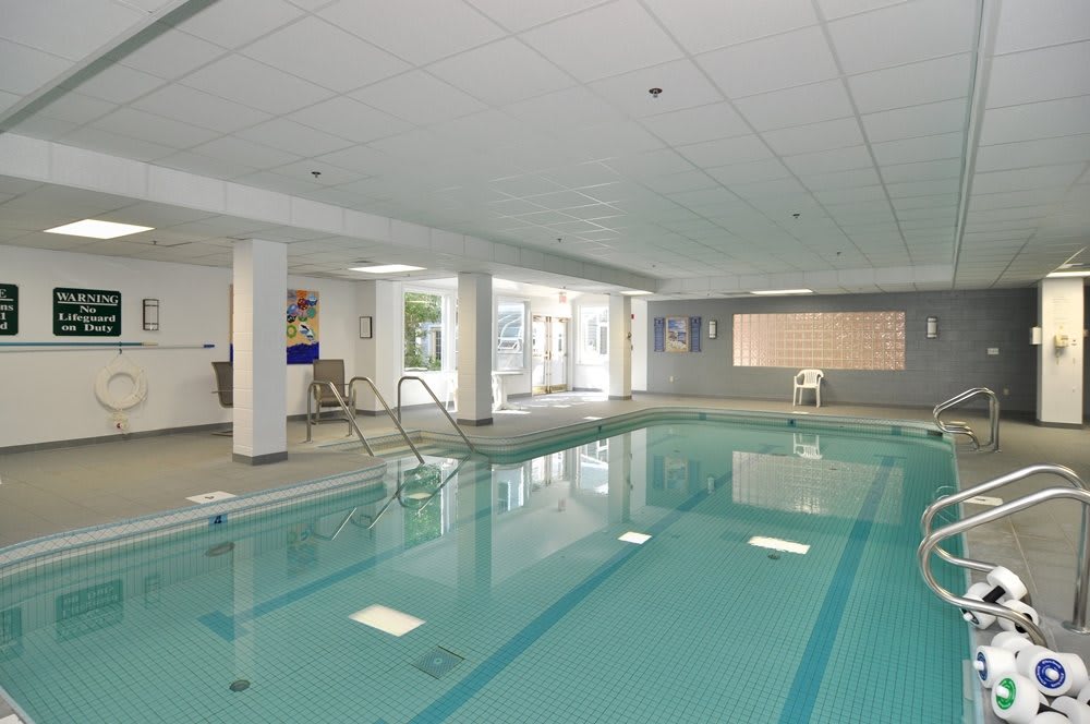 An indoor swimming pool area with clear, inviting water.