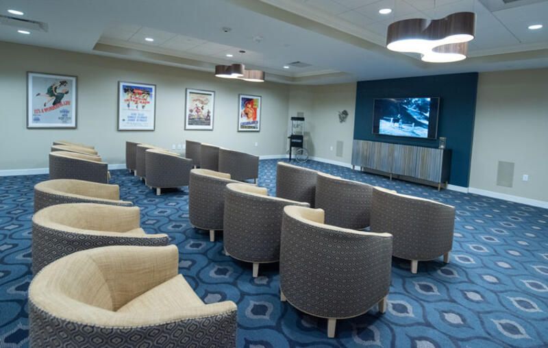 A cozy theater room with comfortable seating and a large screen for viewing.