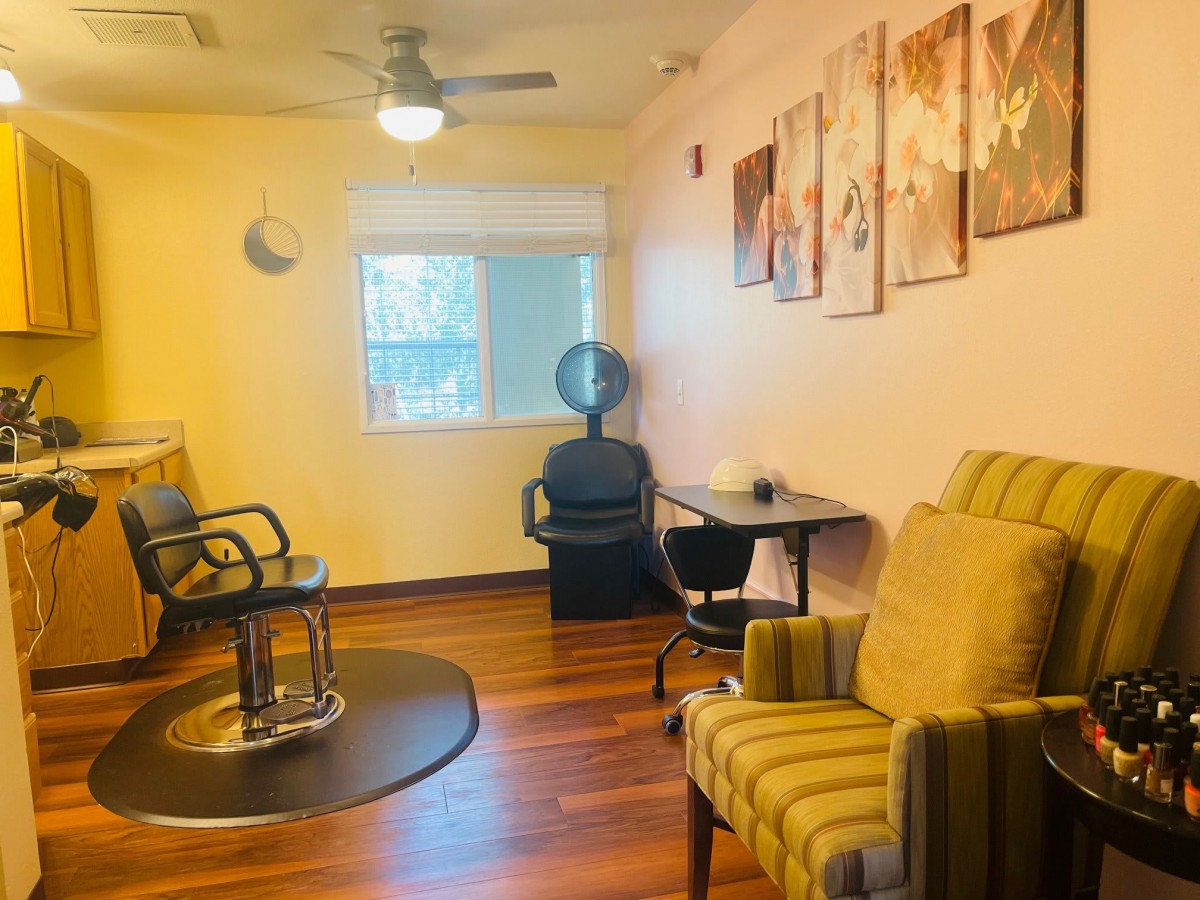 Cozy hair salon interior with styling stations and waiting area.