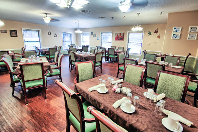 A spacious dining room with neatly arranged tables and chairs, ready for guests.