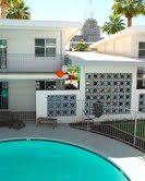 A mid-century modern house with a swimming pool in the foreground.