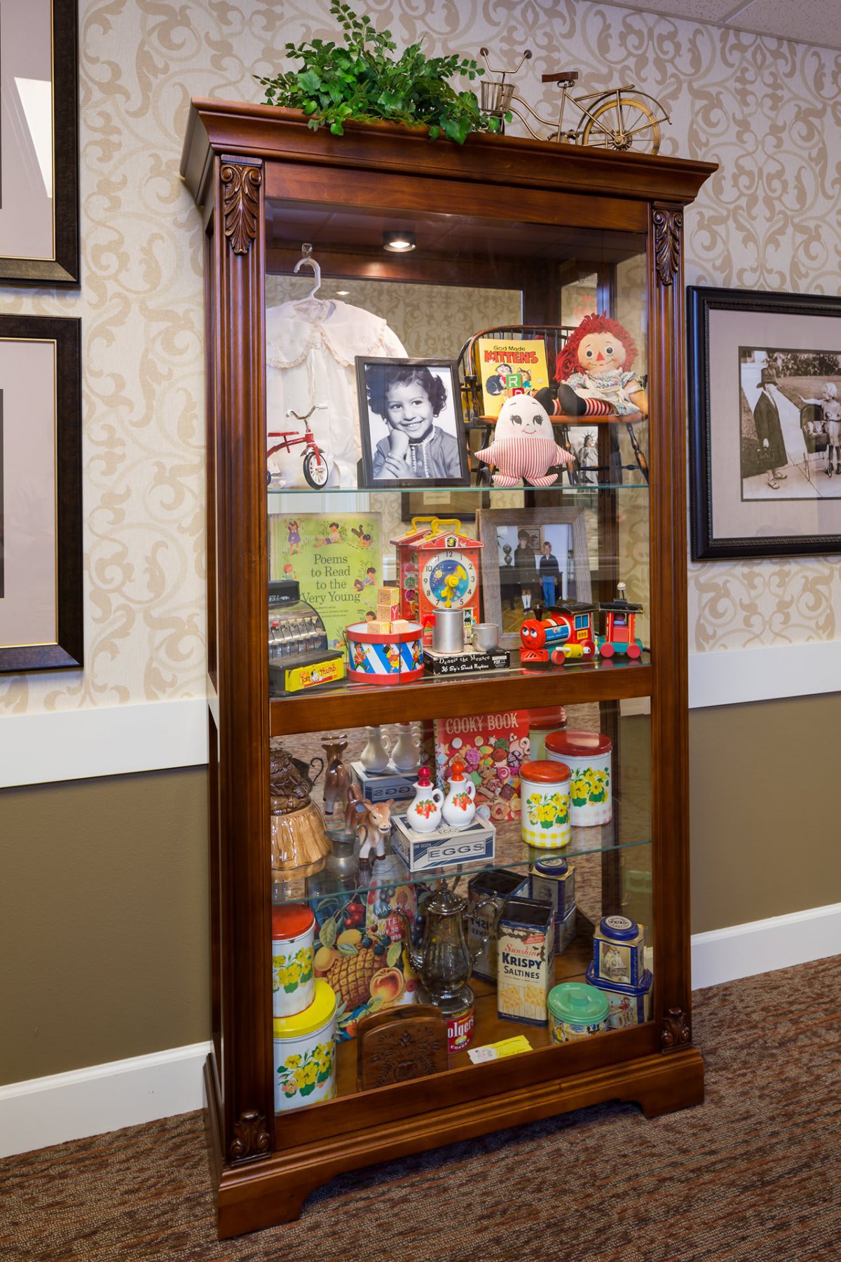 A display cabinet filled with vintage toys and memorabilia, showcasing nostalgic items from past decades.