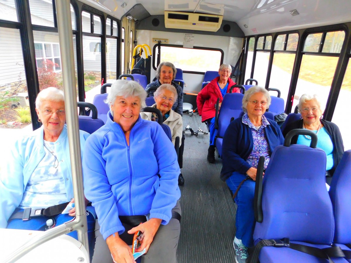 A group of seniors traveling together on a bus.