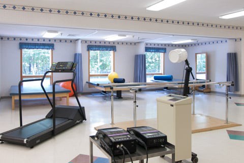 A rehabilitation center equipped with exercise machines and therapy tools.
