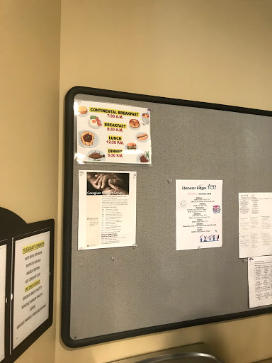A bulletin board displaying various menus and announcements at a restaurant.
