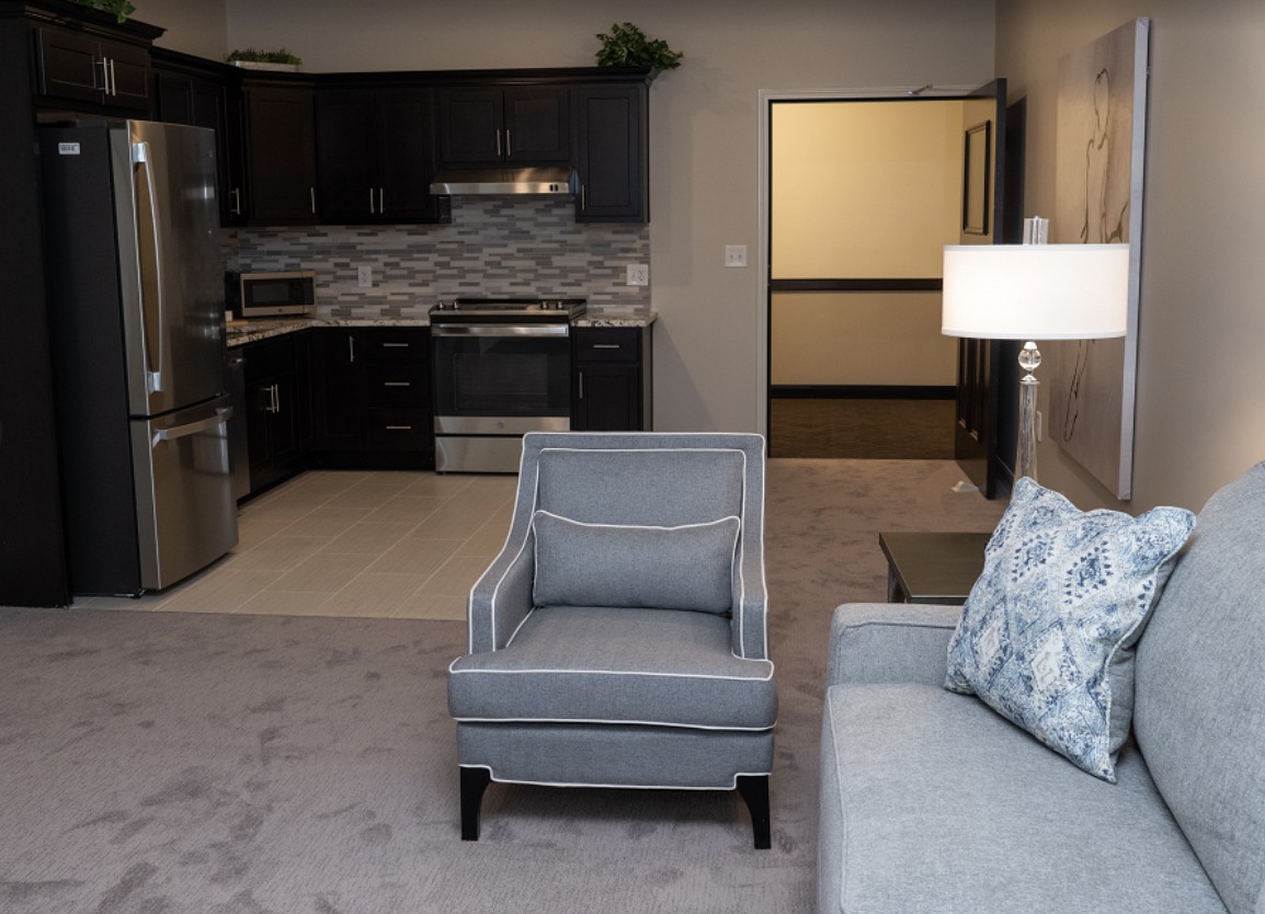 A modern apartment with a cozy living area and a connected kitchen.