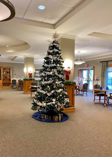 A beautifully decorated Christmas tree in the lobby, surrounded by festive decorations.