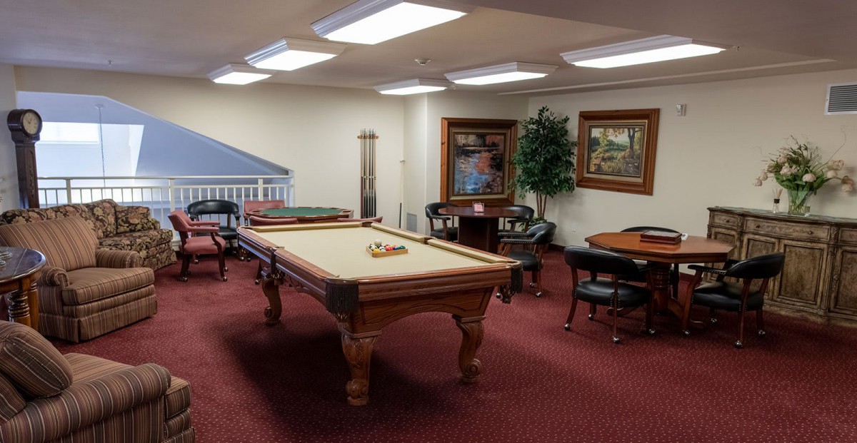 A cozy game room featuring a pool table and seating area.