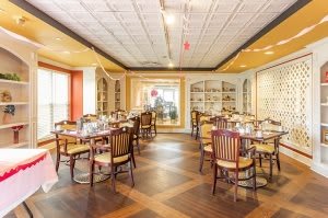 A beautifully arranged restaurant dining area with neatly set tables and elegant interior decor.