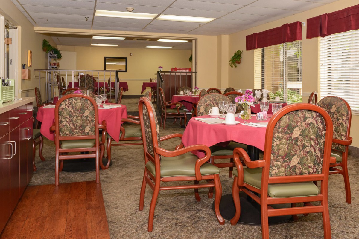 A well-decorated dining area with tables and chairs set for a meal.