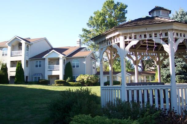 A scenic residential area featuring a gazebo and well-maintained lawns.