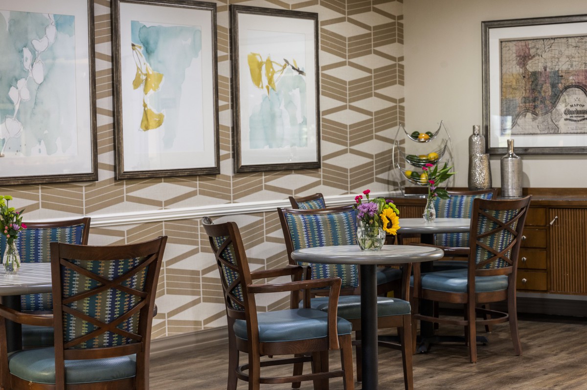 A modern dining area with elegant furnishings and artistic wall decor.