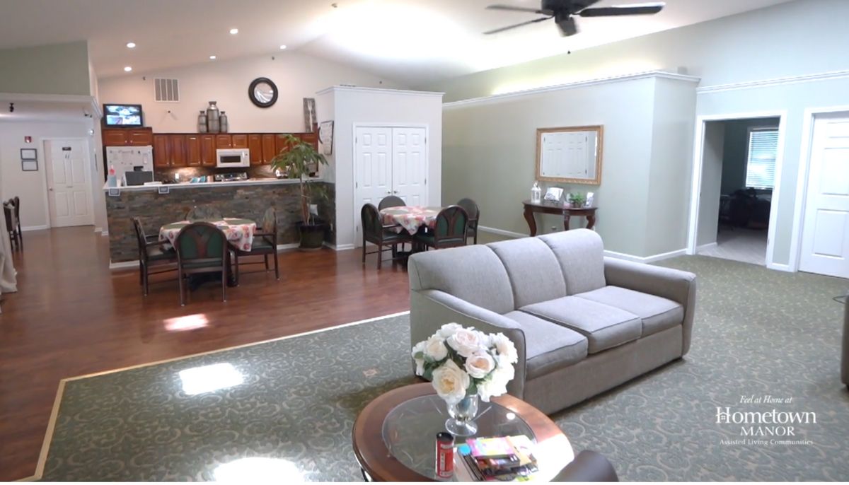 A spacious living room with a sofa, dining table, and modern decor in an open-plan layout.