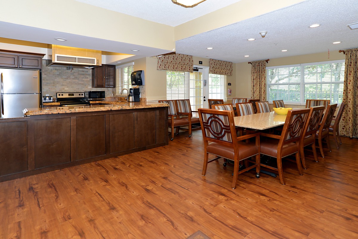 A spacious open-concept kitchen and dining area with hardwood floors and modern furnishings.
