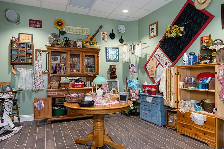 A cozy, vintage-themed kitchen with rustic furniture and antique decor.