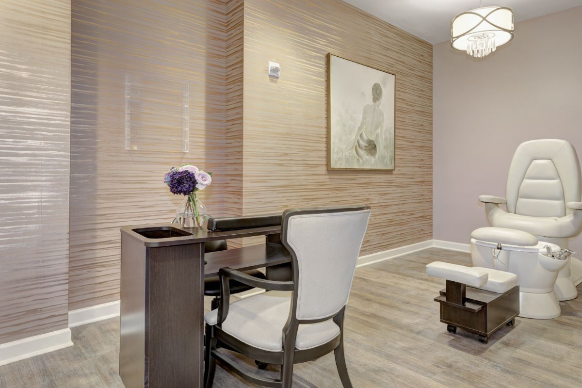 A minimalist office space featuring a desk, chair, and wall art.