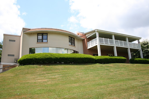 A beautifully designed modern house set on a lush green lawn.