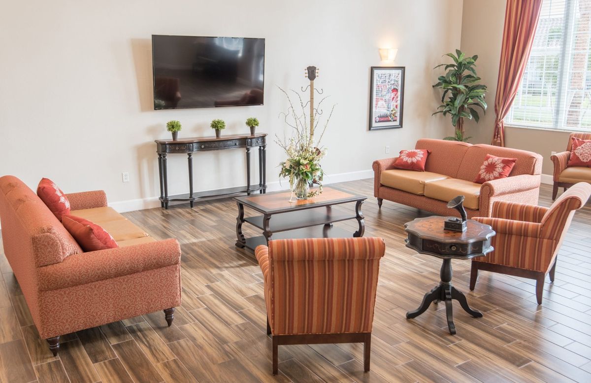 A cozy living room with comfortable seating and a large TV.
