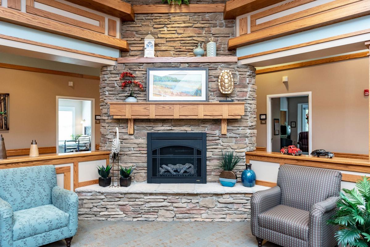 A cozy living room with a stone fireplace and elegant decor.