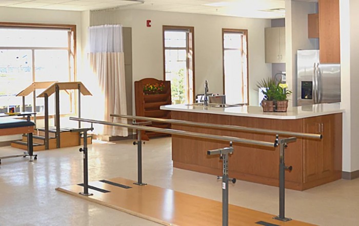 A rehabilitation room with parallel bars used for physical therapy.